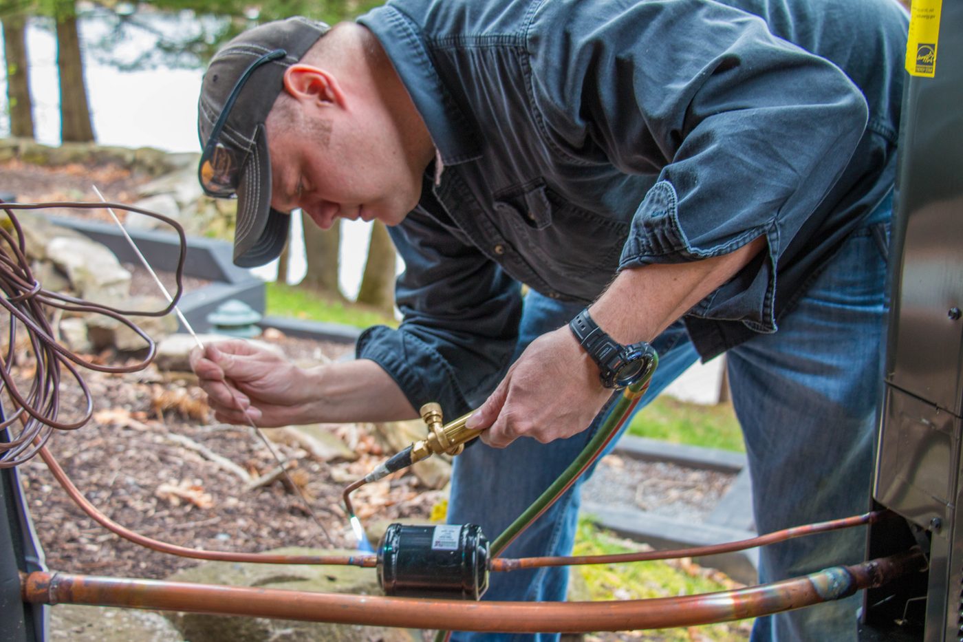 A technician brazing a refrigerant line