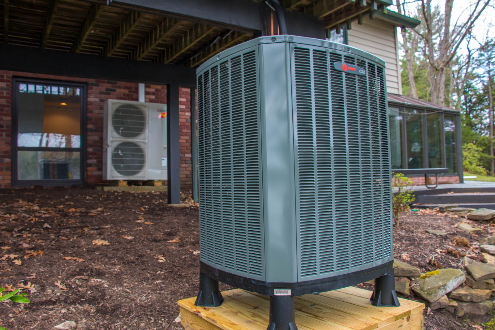 A Trane outdoor unit and a Mitsubishi heat pump at a lake house